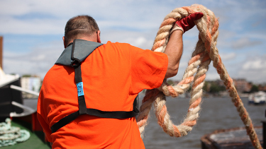 One of the last Thames Watermen and Lightermen prepares to throw a mooring rope
